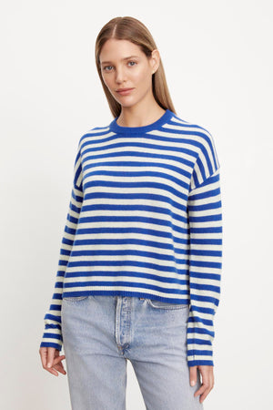 The model is wearing the ALYSSA CASHMERE STRIPED CREW NECK SWEATER from Velvet by Graham & Spencer.