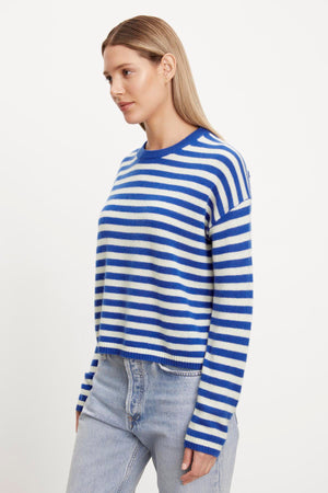 The model is wearing a Velvet by Graham & Spencer ALYSSA CASHMERE STRIPED CREW NECK SWEATER.