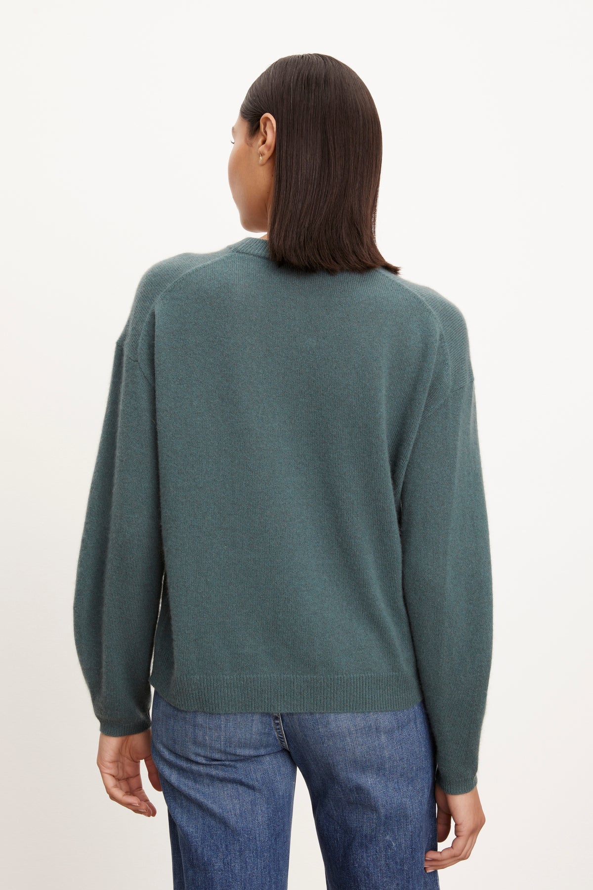 The back view of a woman wearing a Velvet by Graham & Spencer BRYNNE CASHMERE CREW NECK SWEATER and jeans.-26883604414657