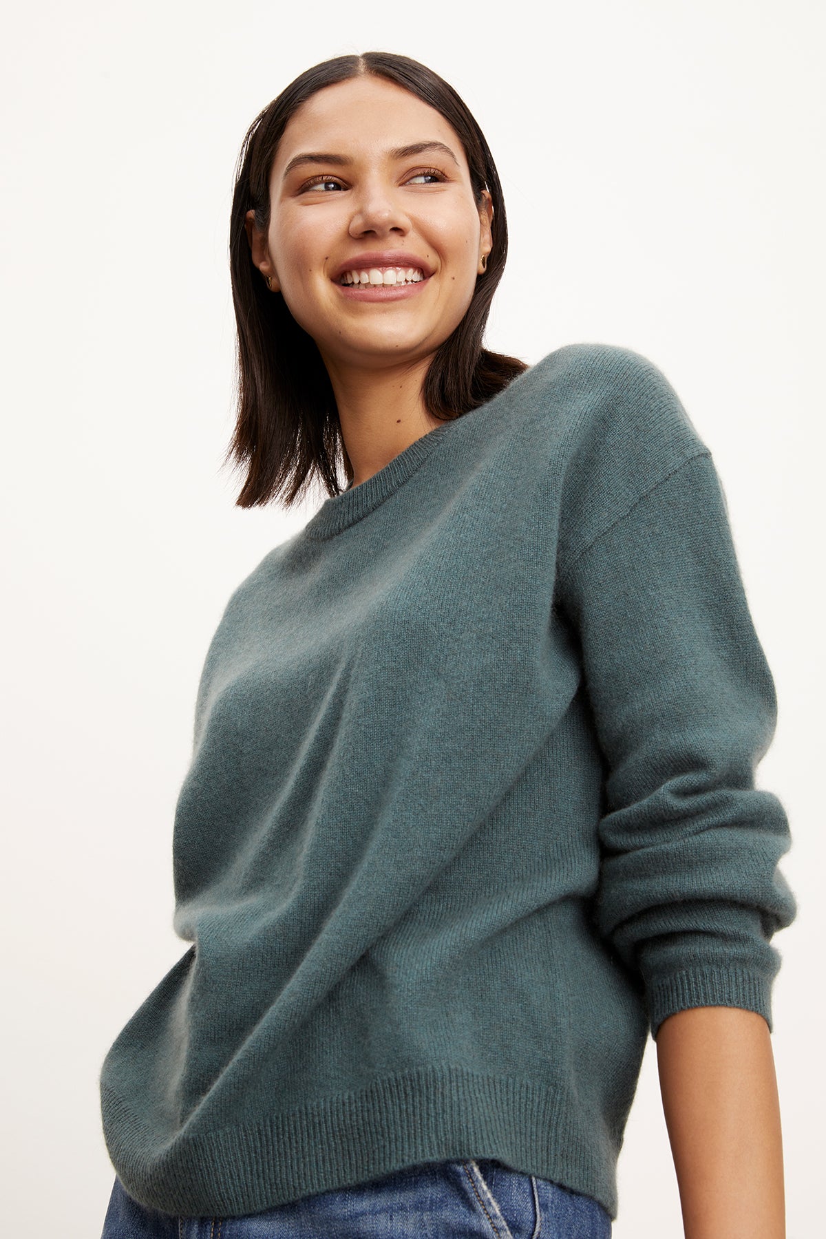   The model is wearing a green Velvet by Graham & Spencer cashmere sweater with ribbed trims. 