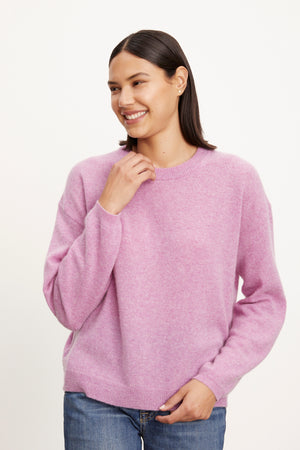 A woman wearing a relaxed Velvet by Graham & Spencer BRYNNE CASHMERE CREW NECK SWEATER.