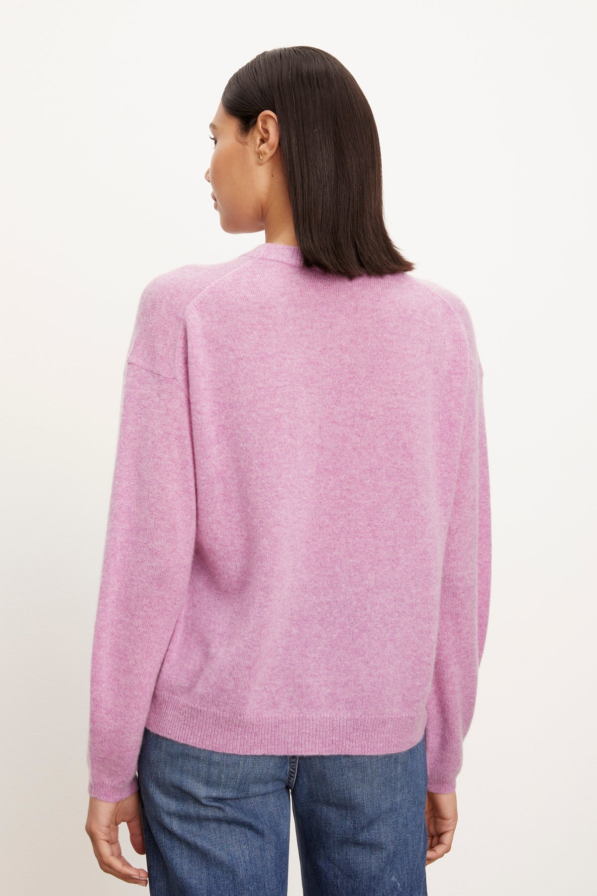 The relaxed back view of a woman wearing a Velvet by Graham & Spencer BRYNNE CASHMERE CREW NECK SWEATER.-26883604709569
