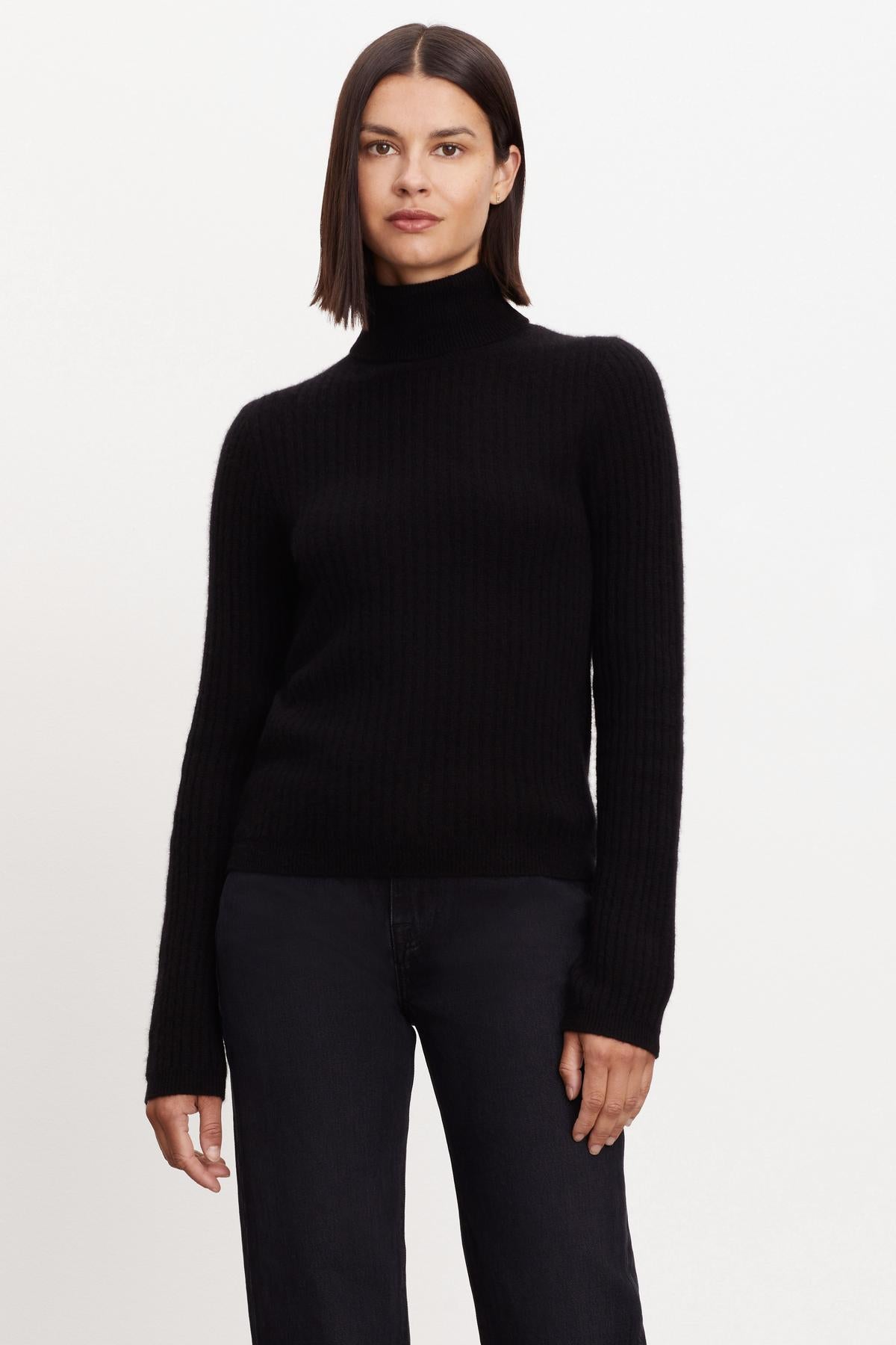   A woman wearing a Velvet by Graham & Spencer LORI CASHMERE TURTLENECK SWEATER. 