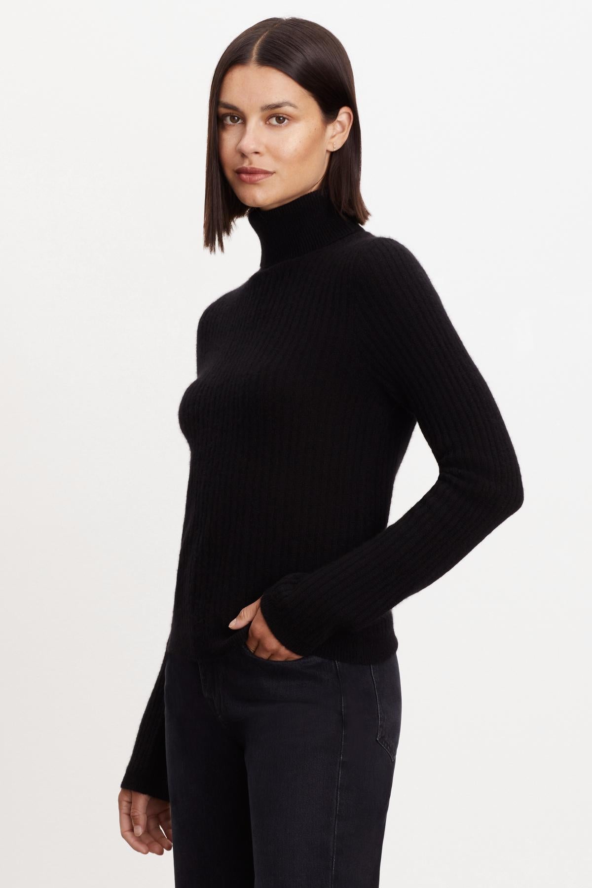 A model wearing a Velvet by Graham & Spencer LORI CASHMERE TURTLENECK SWEATER.-35696186622145