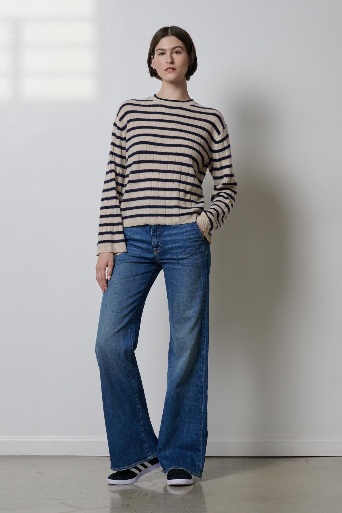 A woman wearing a Velvet by Jenny Graham NAPA sweater and flared jeans.-26827719082177