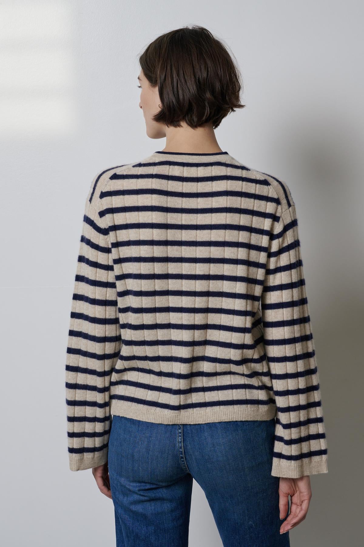 The back view of a woman wearing a Velvet by Jenny Graham NAPA SWEATER and jeans.-26827719049409
