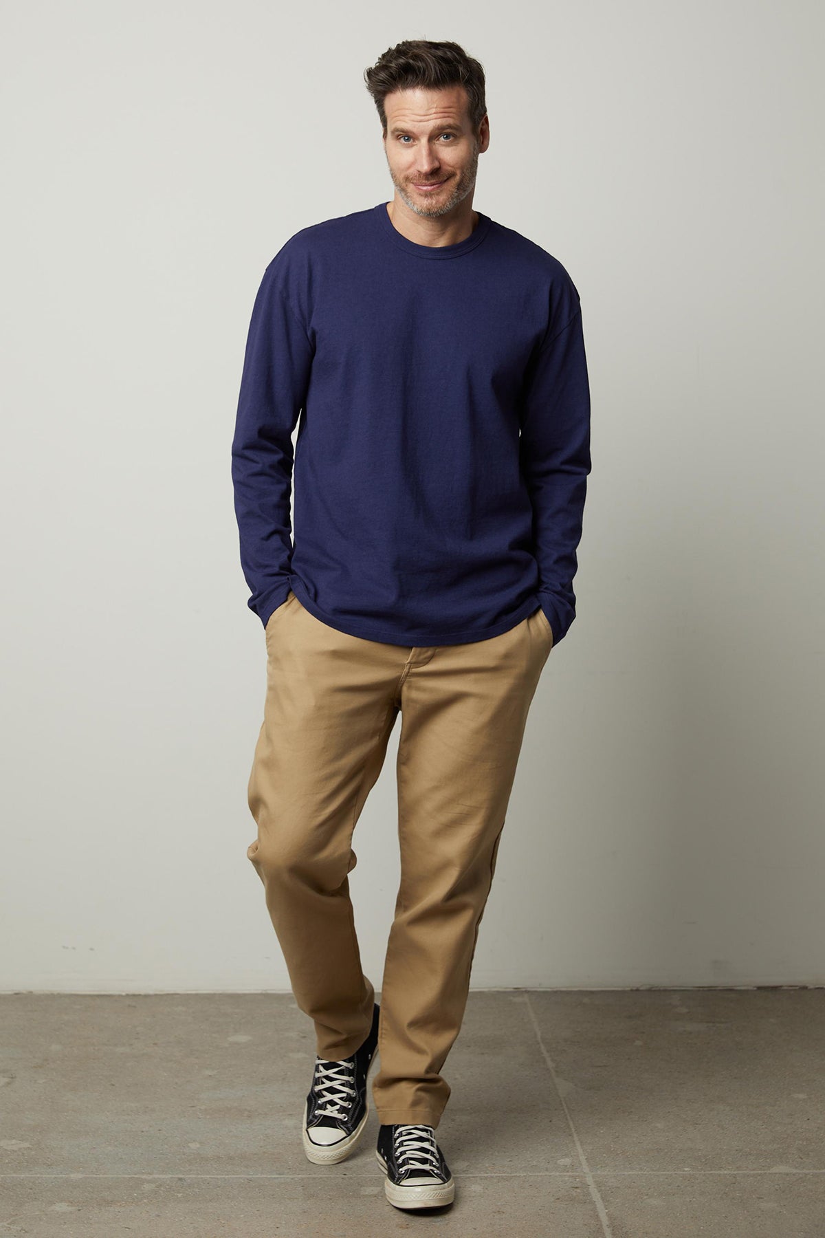 A man wearing a Velvet by Graham & Spencer Edward Crew Neck Tee and khaki pants.-35472062283969