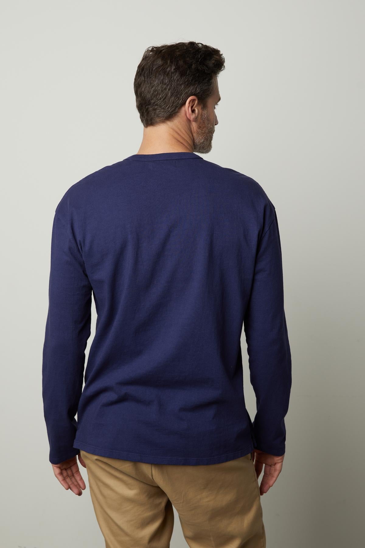 The back view of a man wearing a Velvet by Graham & Spencer EDWARD CREW NECK TEE.-35472062349505