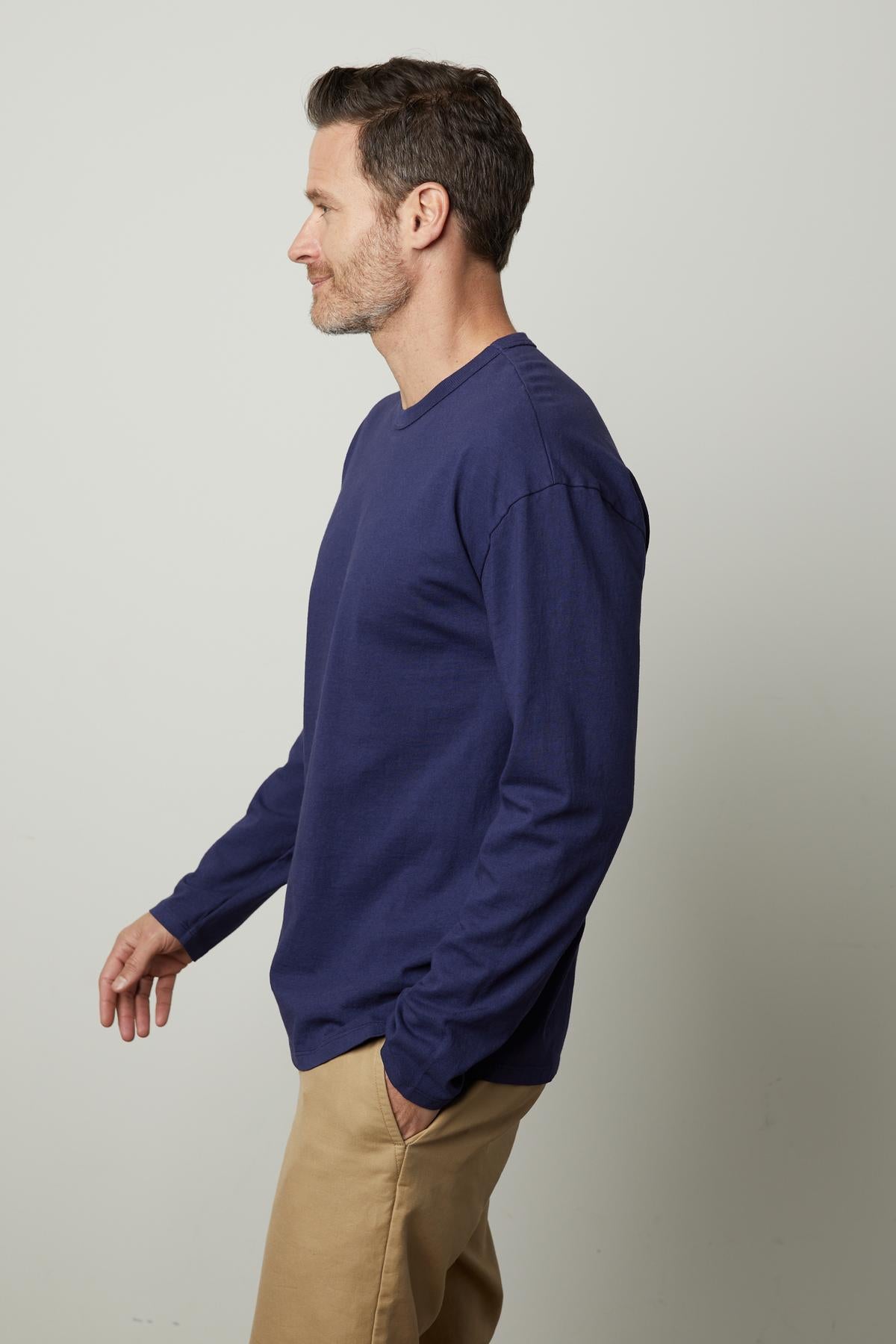   A man wearing an Edward crew neck tee by Velvet by Graham & Spencer. 
