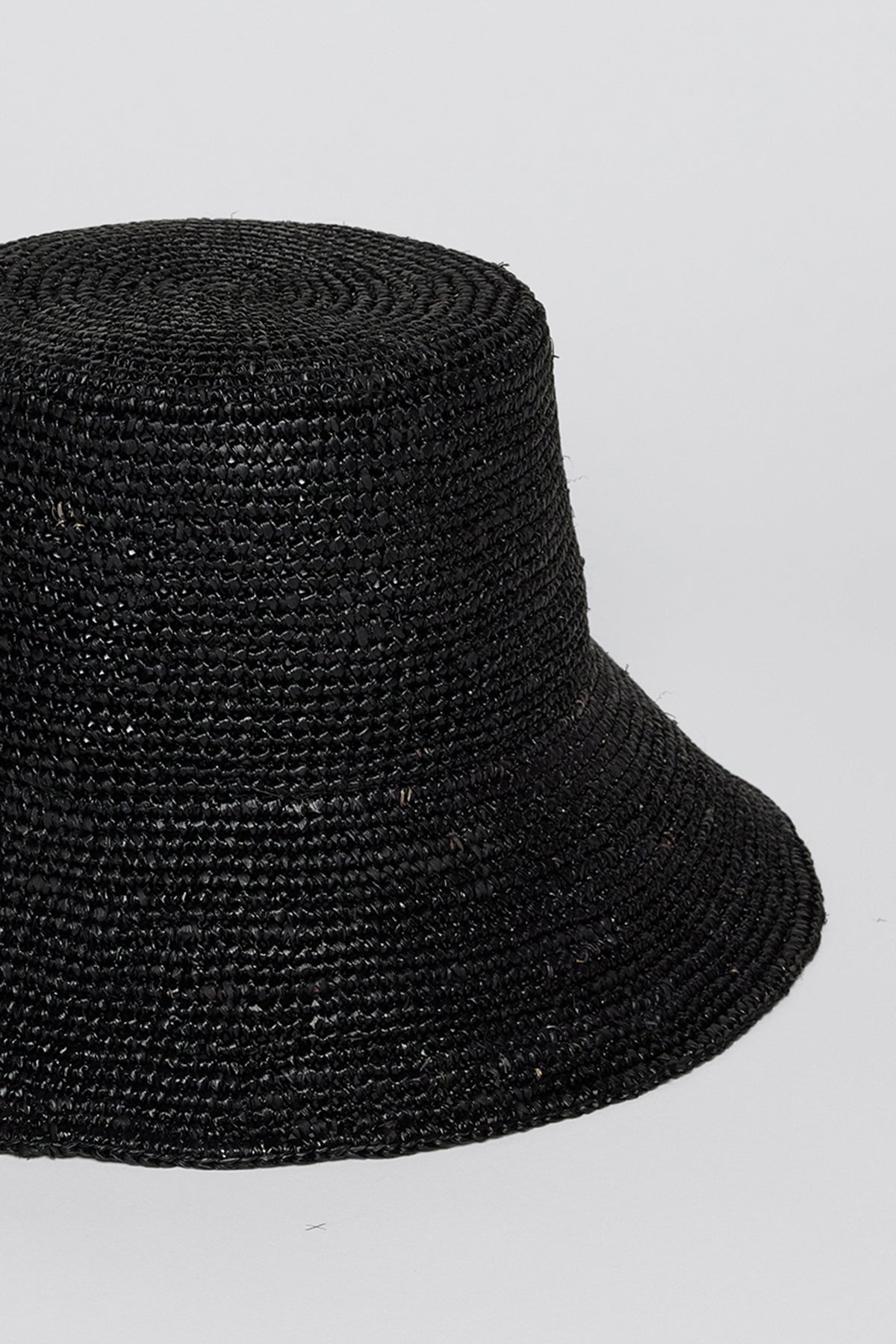   Velvet by Graham & Spencer CHIC CROCHET BUCKET HAT with a textured weave design, isolated on a light gray background. 