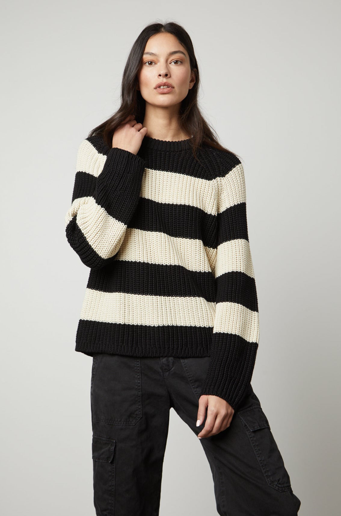 A model wearing the Velvet by Graham & Spencer CIARA STRIPED CREW NECK SWEATER exudes comfort and warmth.-35507445039297
