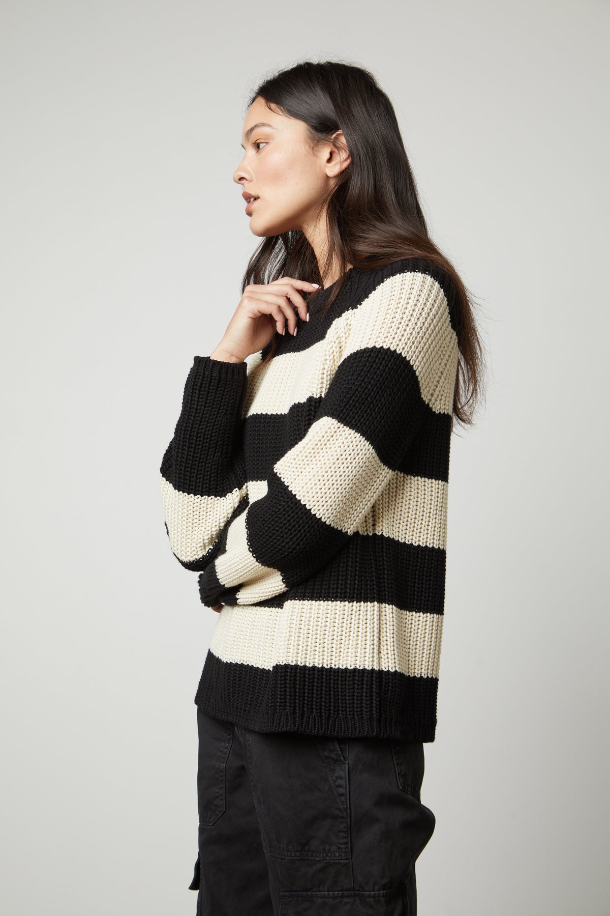   A woman wearing a Velvet by Graham & Spencer CIARA STRIPED CREW NECK SWEATER. 