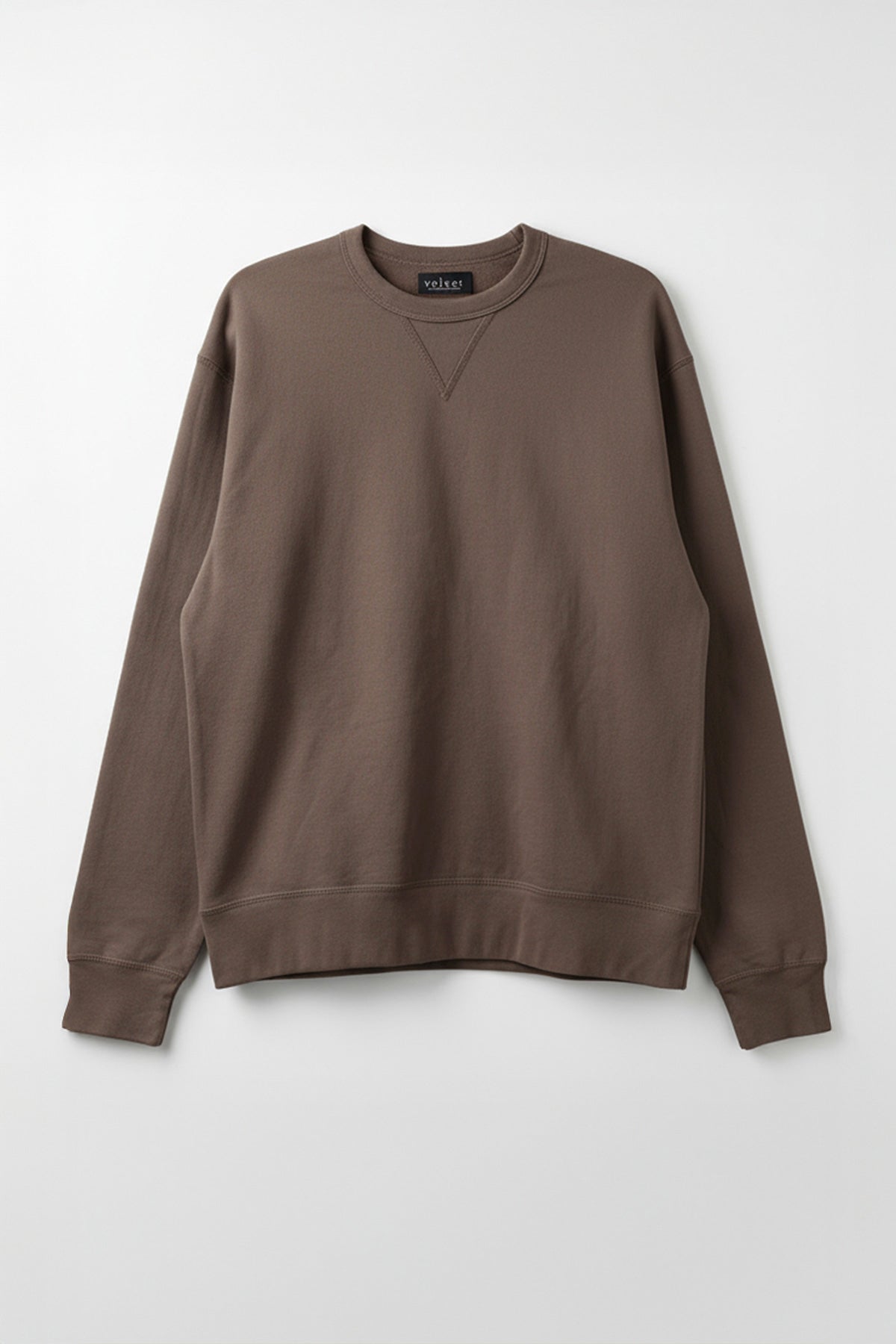 The CILLIAN SWEATSHIRT by Velvet by Graham & Spencer is a vintage-inspired, plain brown crewneck in midweight fleece with long sleeves and ribbed cuffs, hem, and collar, shown against a light gray background.-40277058945217