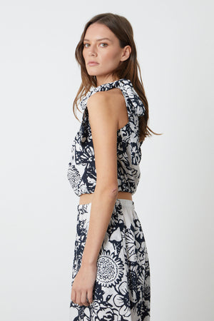 The model is wearing a Velvet by Graham & Spencer blue and white floral print skirt.