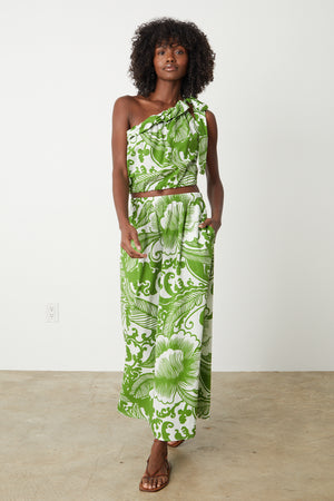 a woman wearing a green and white floral Velvet by Graham & Spencer Juliana printed maxi skirt.