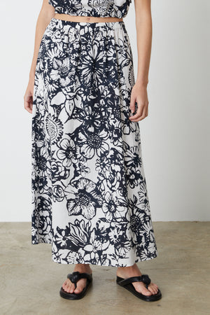 A woman wearing a Velvet by Graham & Spencer Juliana Printed Maxi Skirt.