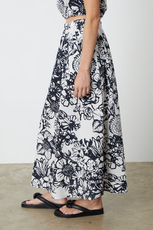 The model is wearing a Velvet by Graham & Spencer Juliana printed maxi skirt.