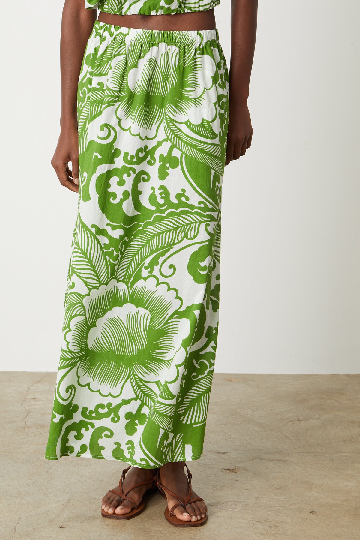 A woman wearing a Velvet by Graham & Spencer Juliana printed maxi skirt.-26342702153921