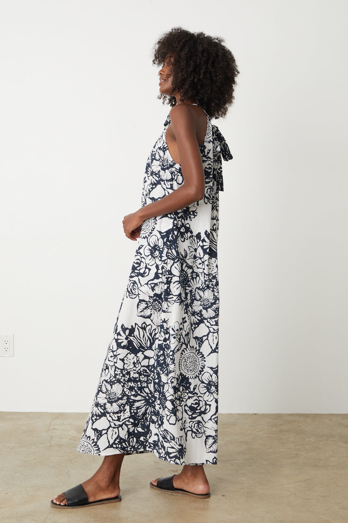   The side view of a woman wearing a Velvet by Graham & Spencer Penelope Printed Maxi Dress. 