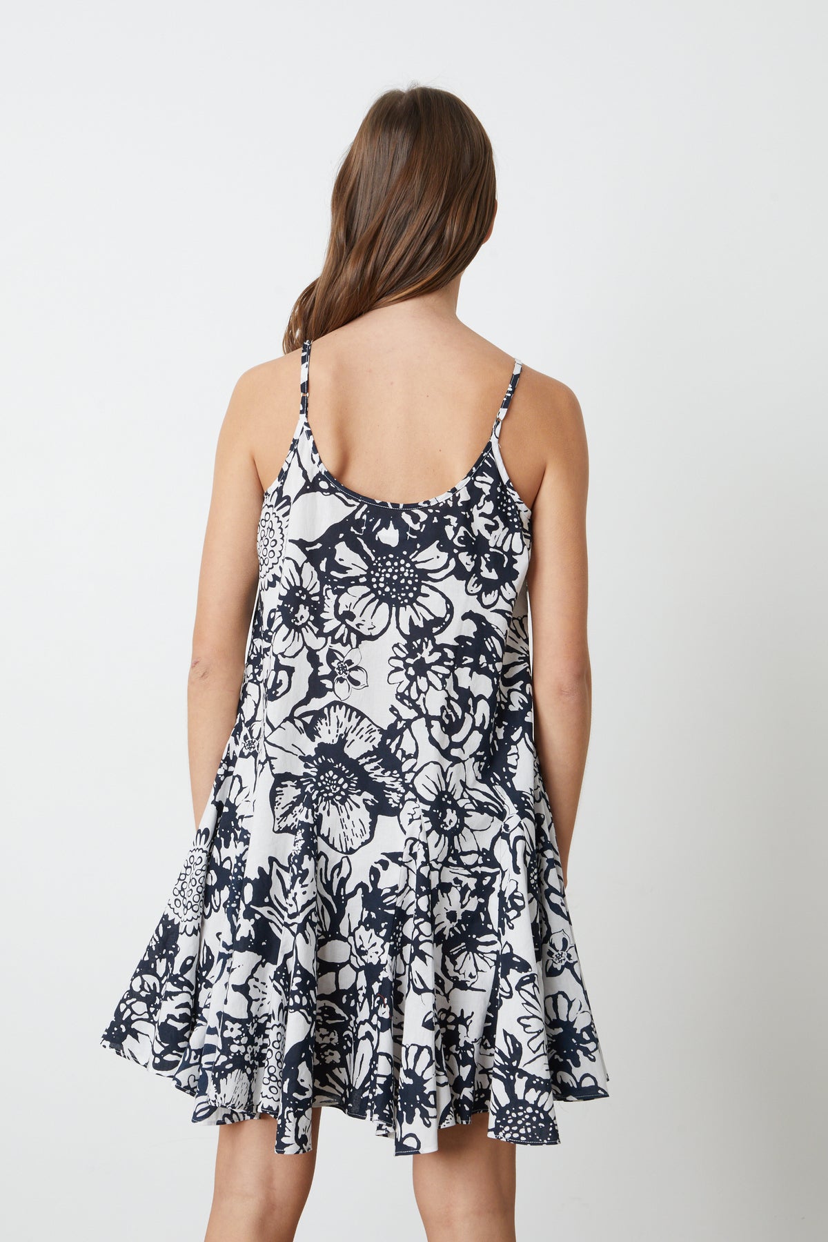   The back view of a woman wearing a Velvet by Graham & Spencer VIVIAN PRINTED DRESS. 