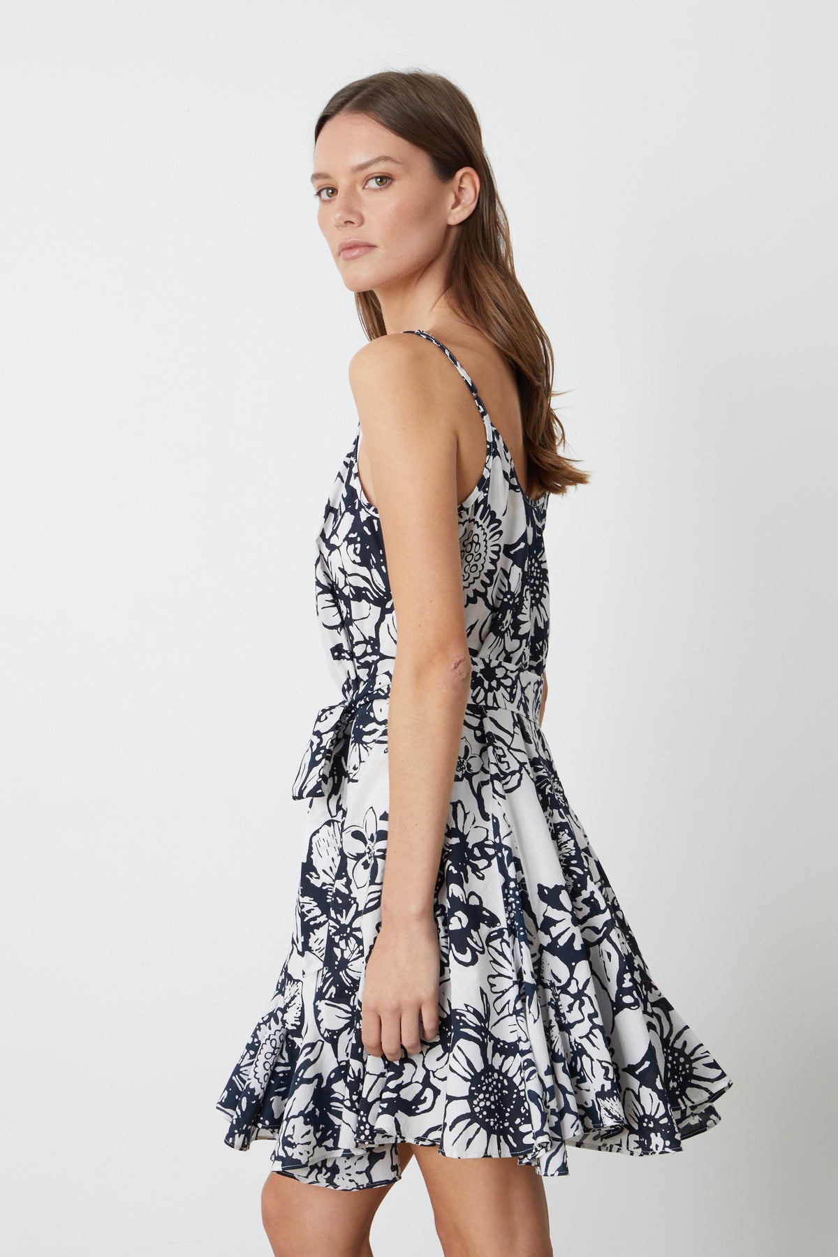   The model is wearing a VIVIAN PRINTED DRESS by Velvet by Graham & Spencer. 