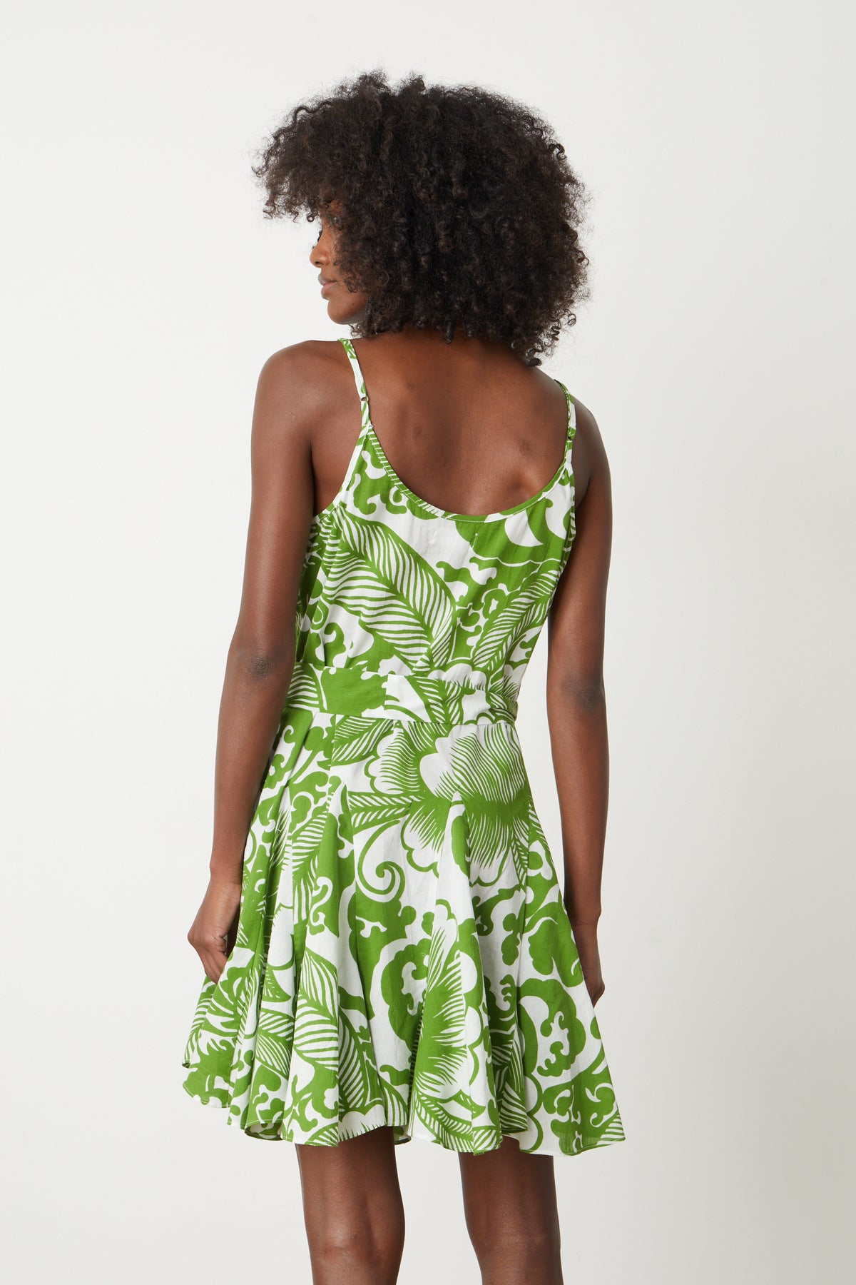 The back view of a woman wearing a Velvet by Graham & Spencer VIVIAN PRINTED DRESS.-26774913515713