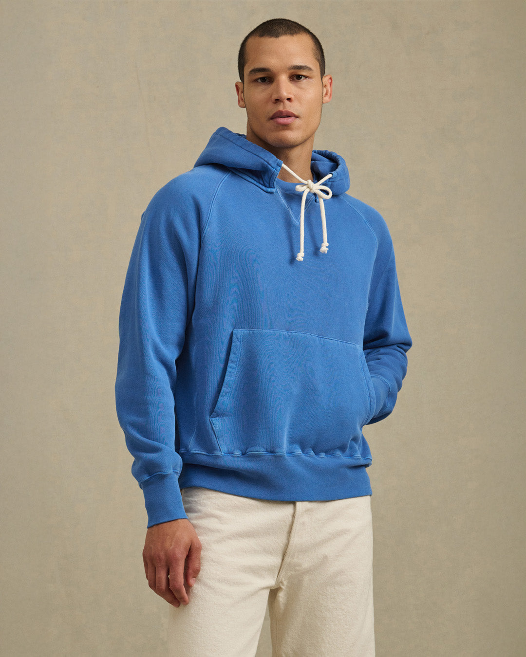 A man wearing the Brodie Tee in Electric by Velvet by Graham & Spencer.