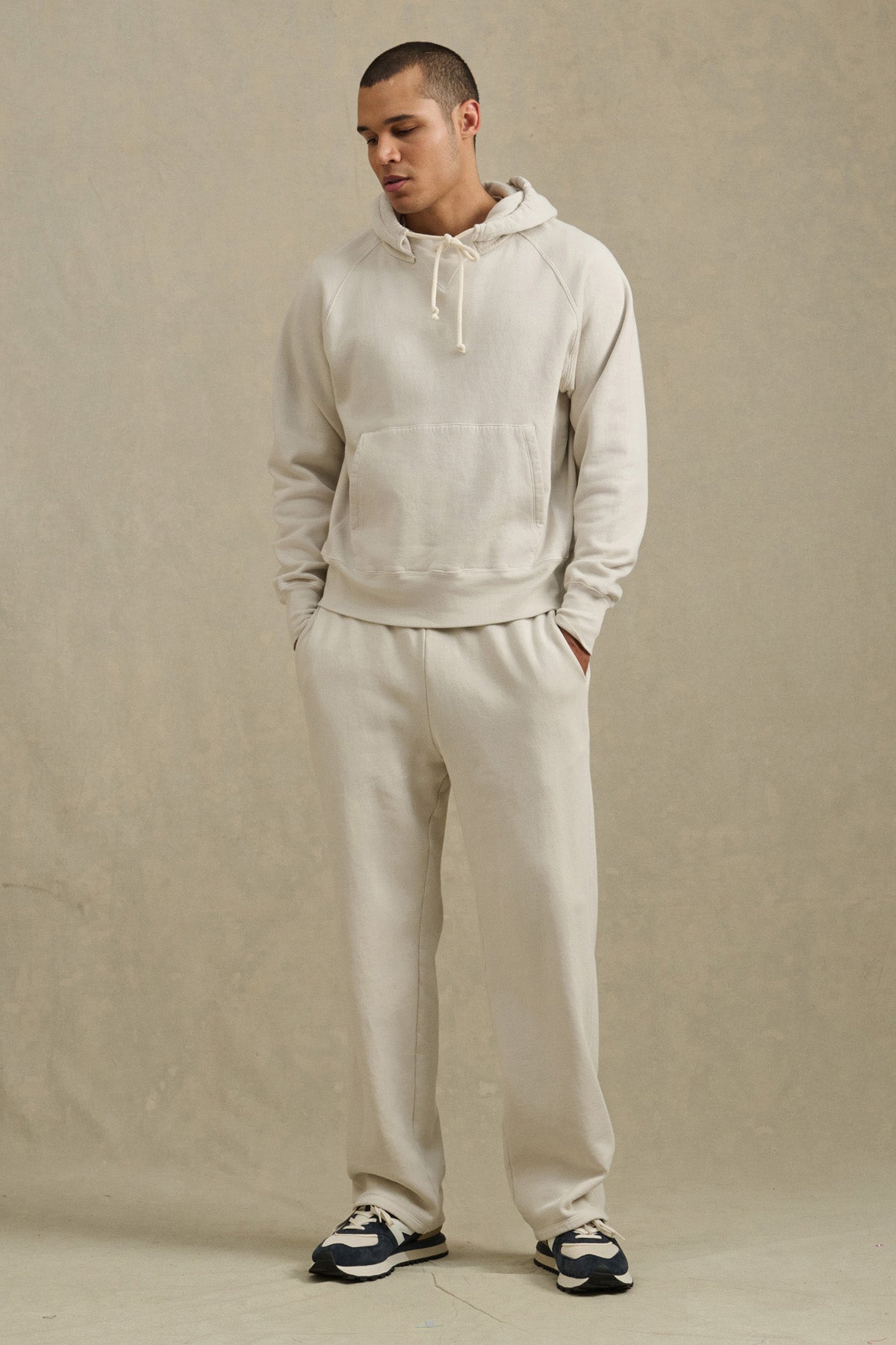 A man in the BRODIE HOODIE by Velvet by Graham & Spencer, paired with sweatpants.-40850658033857
