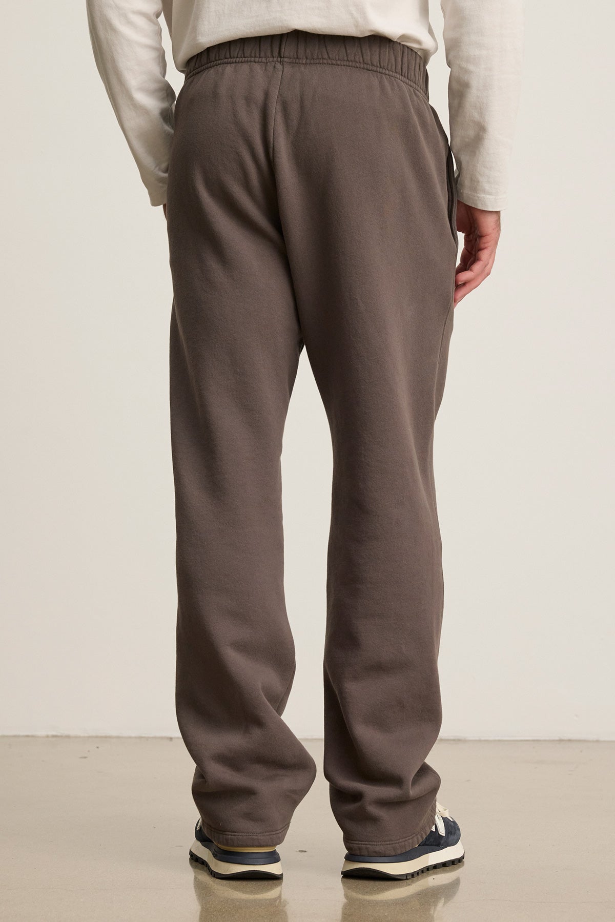 Someone wearing the HUDSON SWEATPANT by Velvet by Graham & Spencer, paired with a white long-sleeve shirt and navy sneakers, stands with their back to the camera against a plain background.-40276964671681