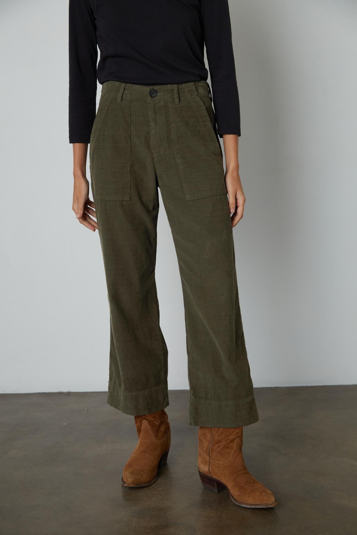 A woman wearing VERA CORDUROY WIDE LEG PANTS by Velvet by Graham & Spencer and black boots.-26727676575937