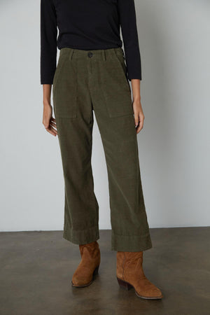 A woman wearing VERA CORDUROY WIDE LEG PANTS by Velvet by Graham & Spencer and black boots.
