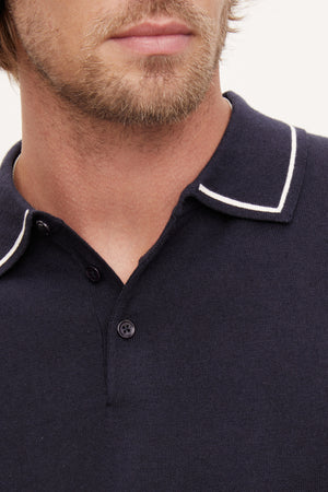 Close-up of a man's lower face and neck showing a Velvet by Graham & Spencer Shepard Polo with white trim on the collar.