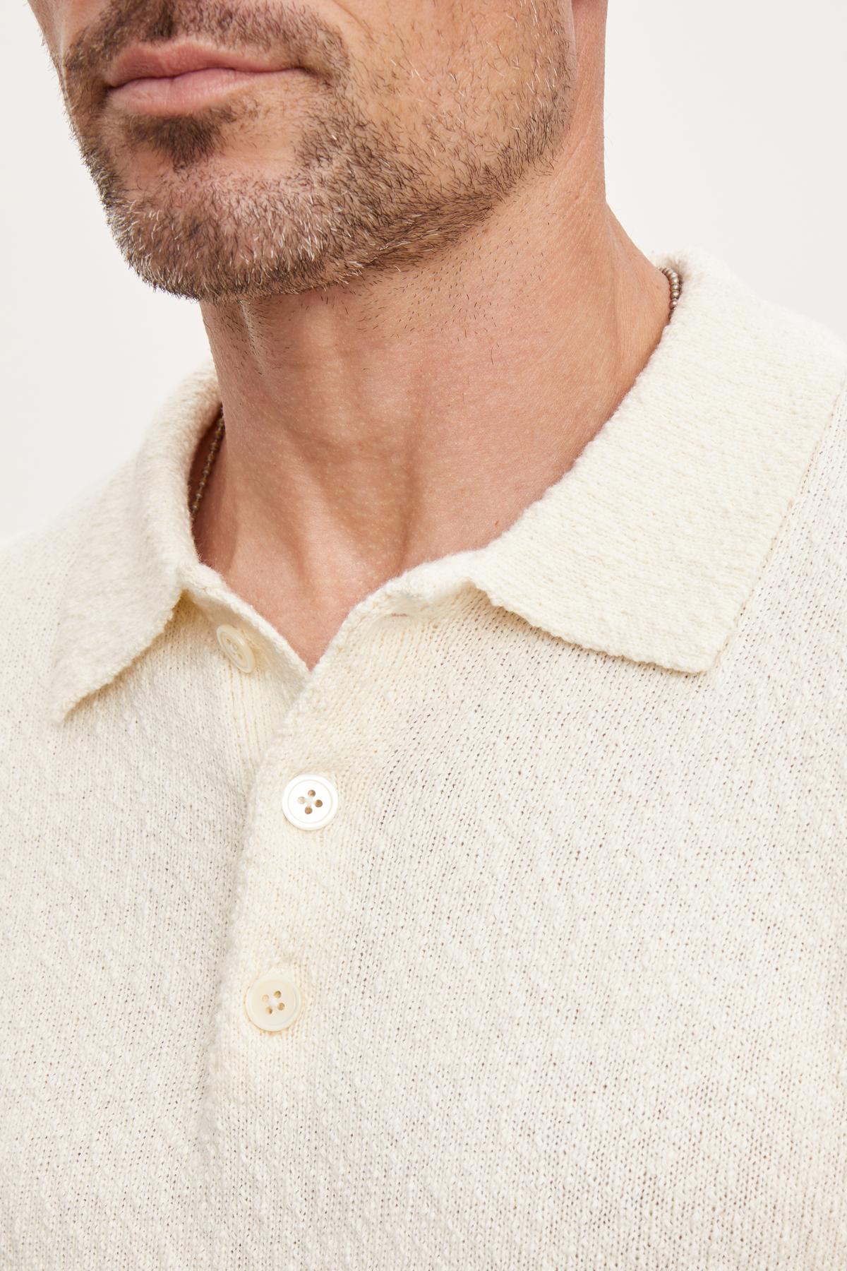  Close-up of a man wearing a Velvet by Graham & Spencer TIBERIUS POLO, focusing on the top portion from the neck to chest. 