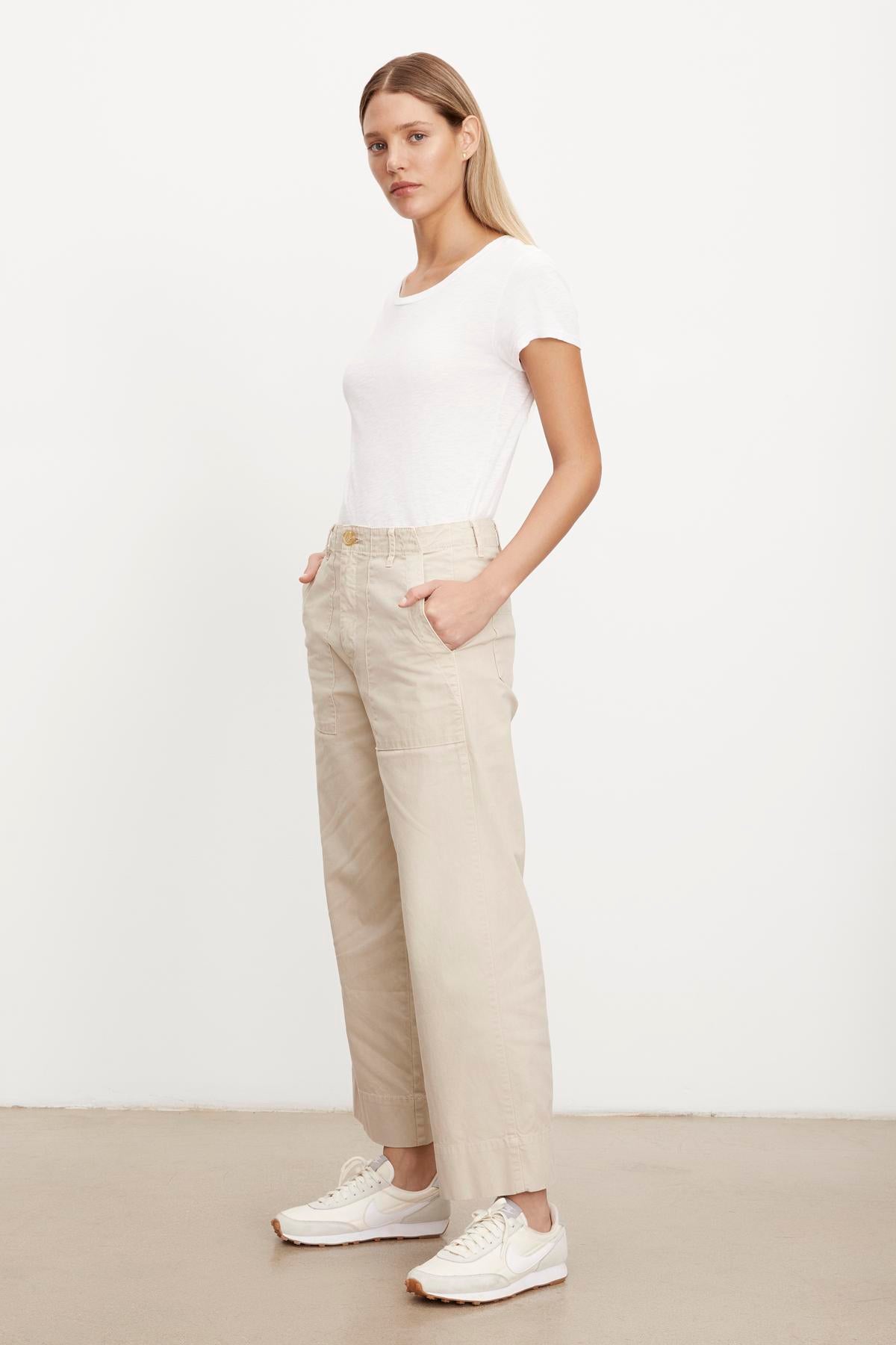   The model is wearing a slim top and MYA COTTON CANVAS PANT trousers by Velvet by Graham & Spencer. 