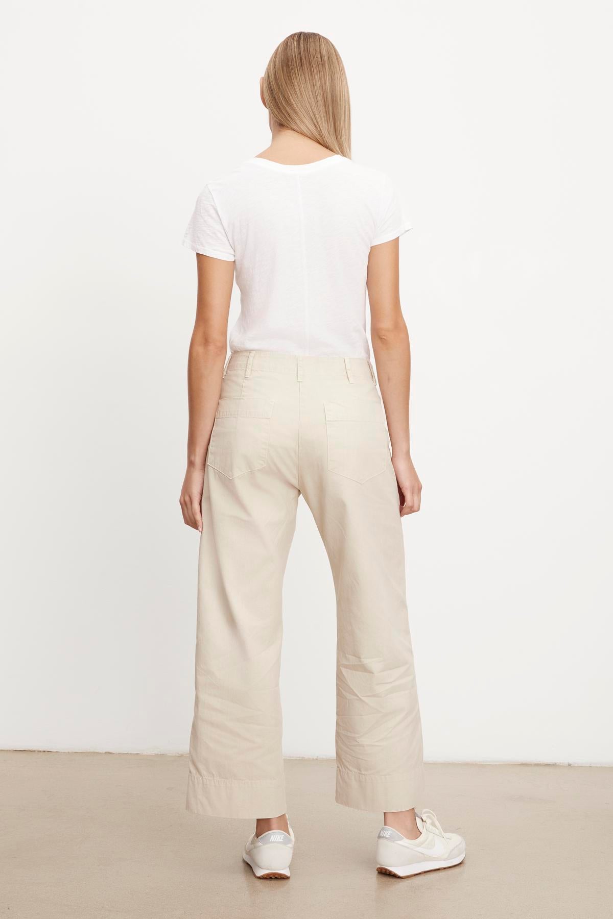   The back view of a woman wearing a white t-shirt and Velvet by Graham & Spencer's MYA COTTON CANVAS PANT. 