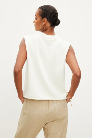 The back view of a woman wearing a Velvet by Graham & Spencer ASTER CREW NECK SWEATER and tan pants.