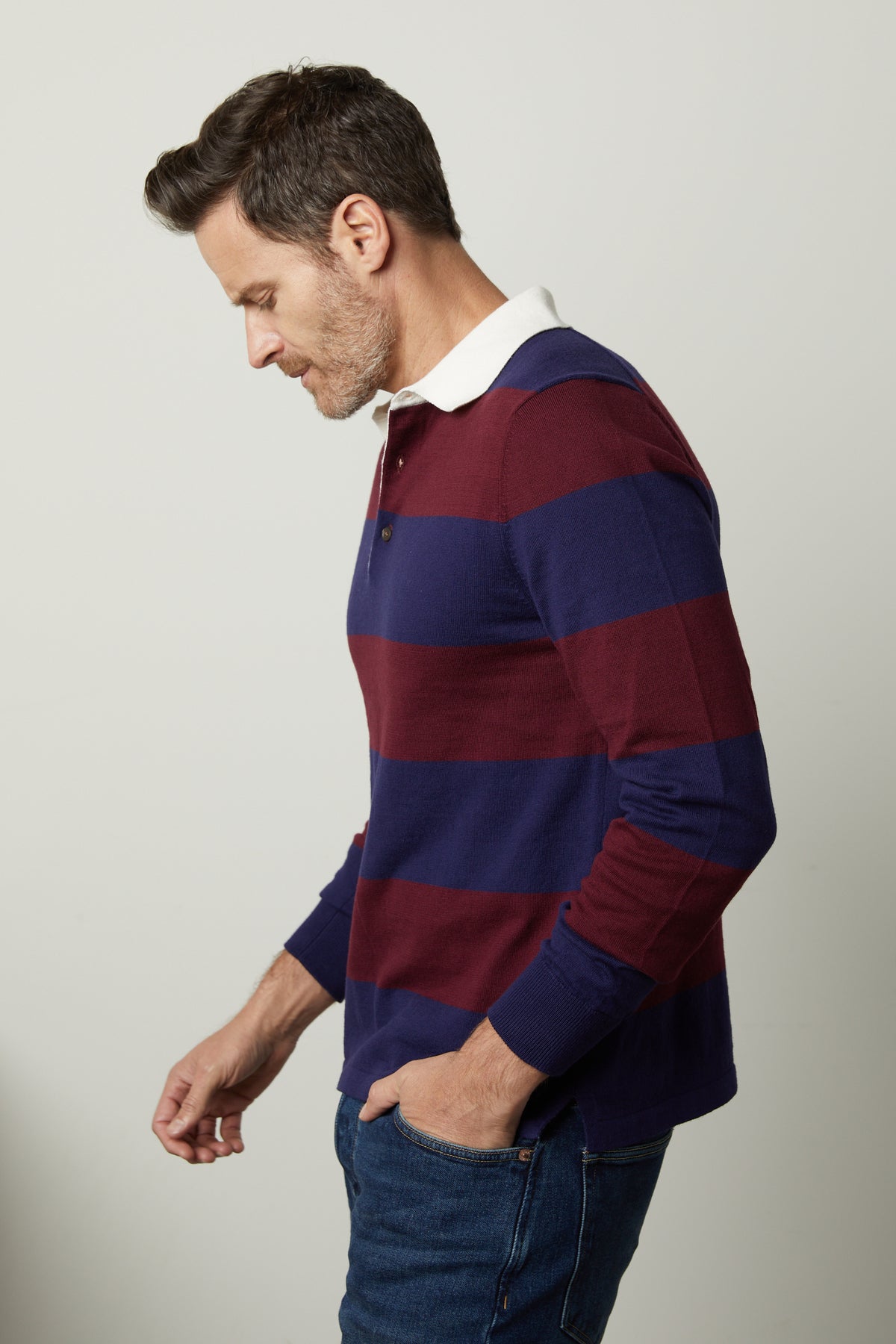   A man wearing a Velvet by Graham & Spencer Hastings Striped Polo Sweater. 