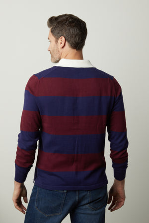 The back view of a man wearing a Velvet by Graham & Spencer HASTINGS STRIPED POLO SWEATER.