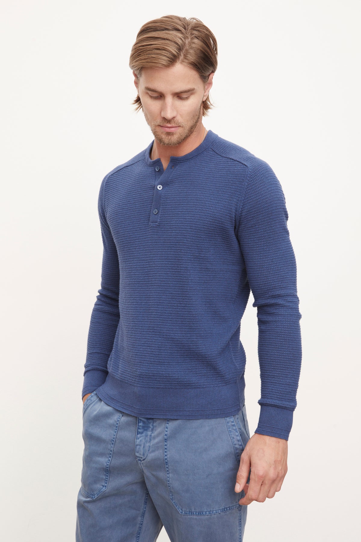   A man wearing a JAKE THERMAL HENLEY by Velvet by Graham & Spencer sweater and JAKE THERMAL HENLEY by Velvet by Graham & Spencer pants. 