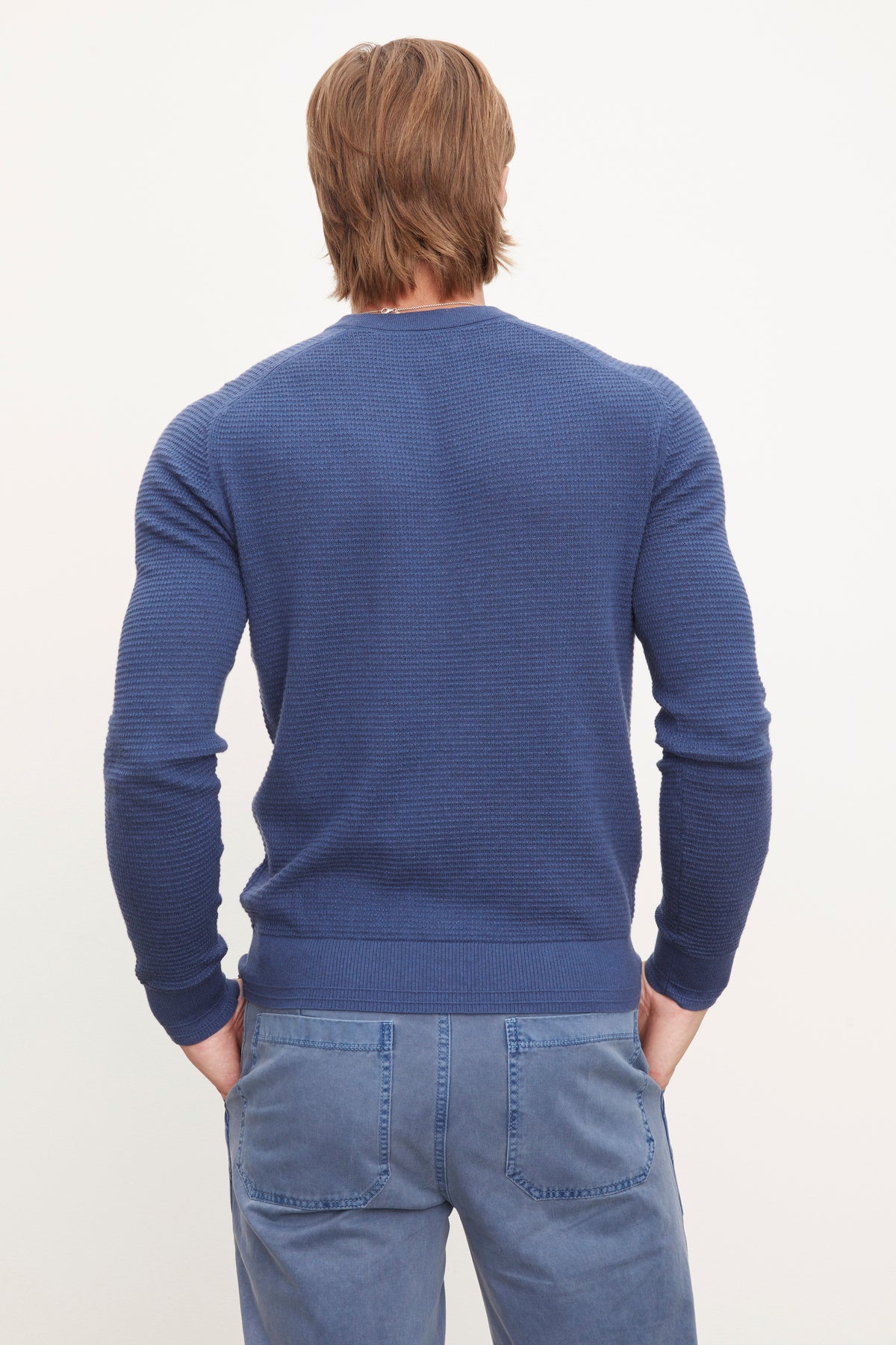   A man in a blue Velvet by Graham & Spencer JAKE THERMAL HENLEY sweater. 