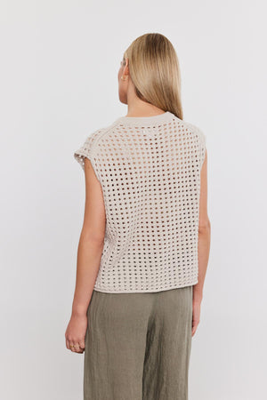 Woman viewed from the back wearing a Velvet by Graham & Spencer MAISON SWEATER and olive green pants against a white background.