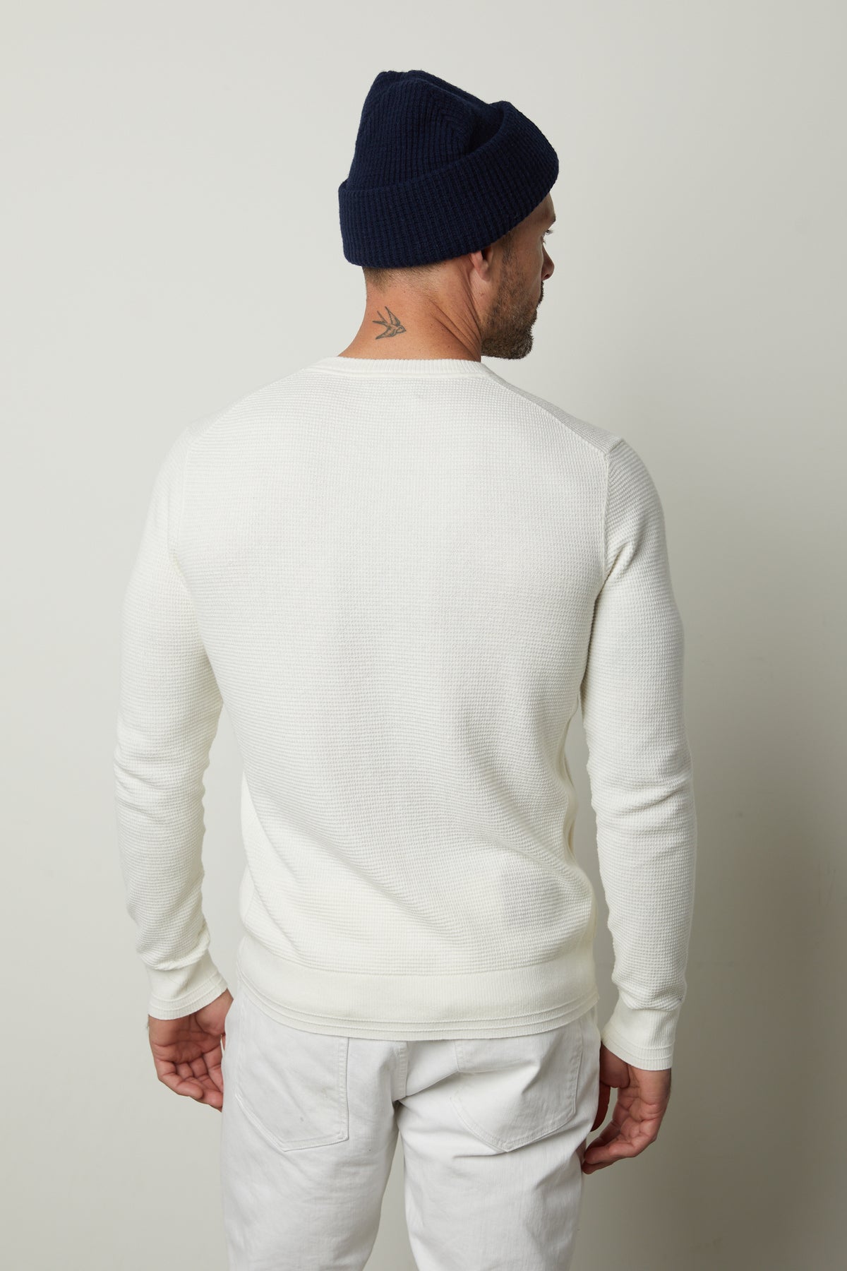 The back view of a man wearing a Velvet by Graham & Spencer WALTER CREW NECK SWEATER and jeans.-26846174478529