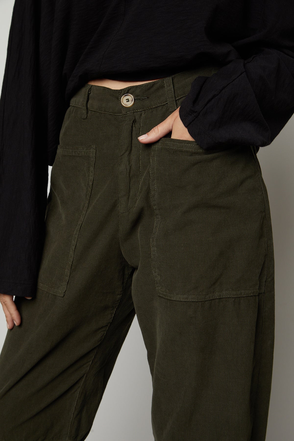 A woman wearing a black top and SUE CORDUROY PANT by Velvet by Graham & Spencer.-26799933456577