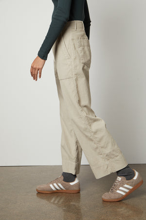 A woman wearing a green sweater and VERA CORDUROY WIDE LEG PANT pants by Velvet by Graham & Spencer.