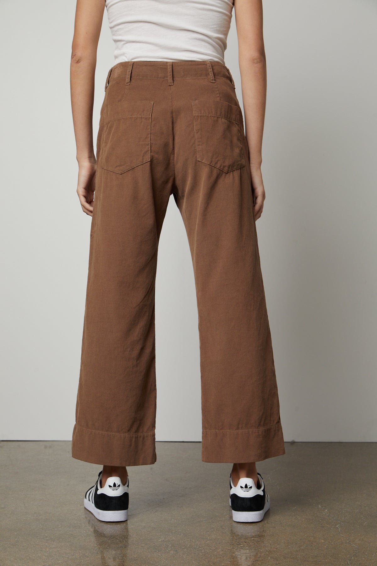 The back view of a woman wearing Velvet by Graham & Spencer's VERA CORDUROY WIDE LEG PANT with utility details.-26914938650817