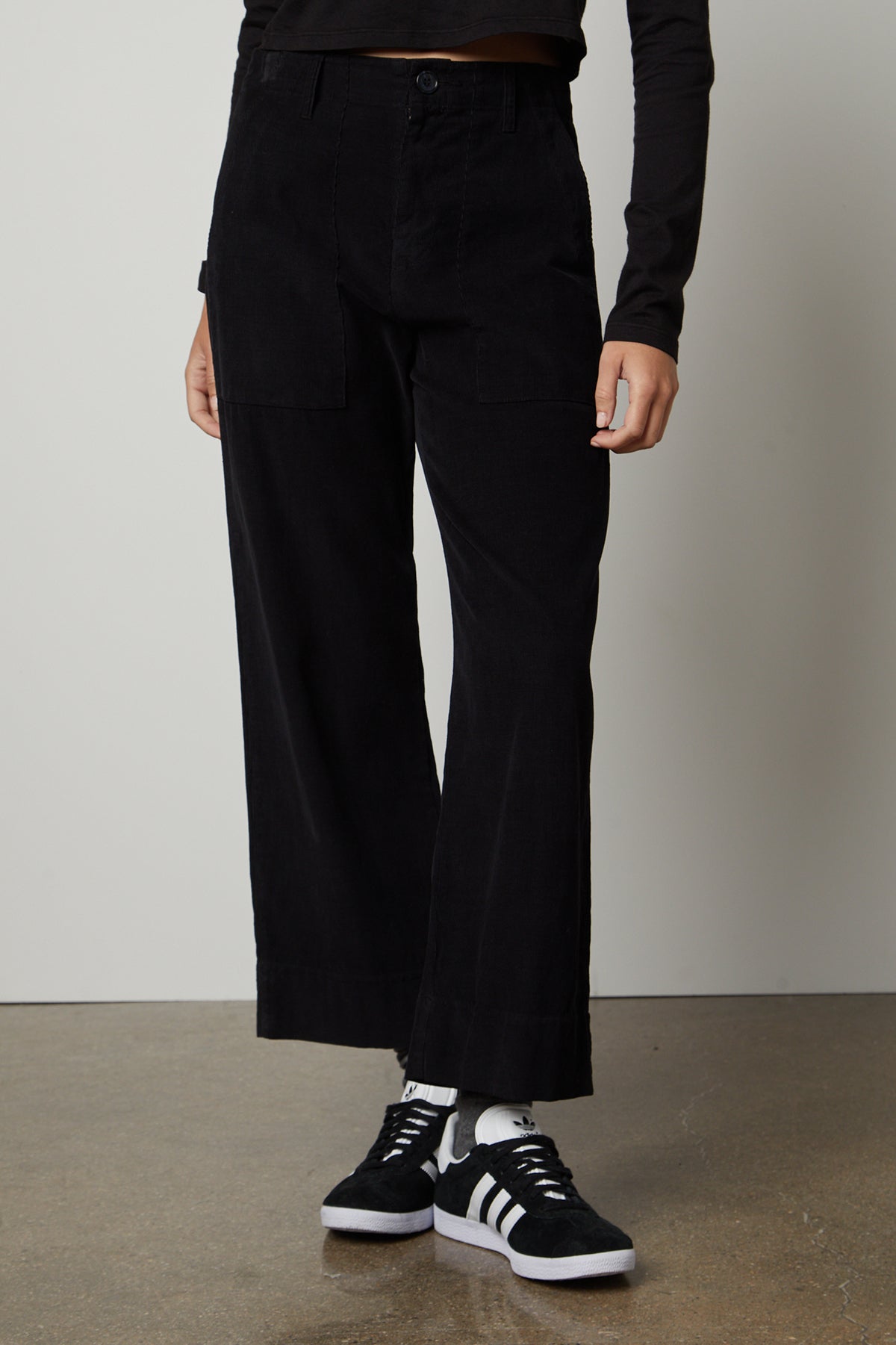 A woman wearing the Velvet by Graham & Spencer VERA CORDUROY WIDE LEG PANT and a white t-shirt.-26861576421569