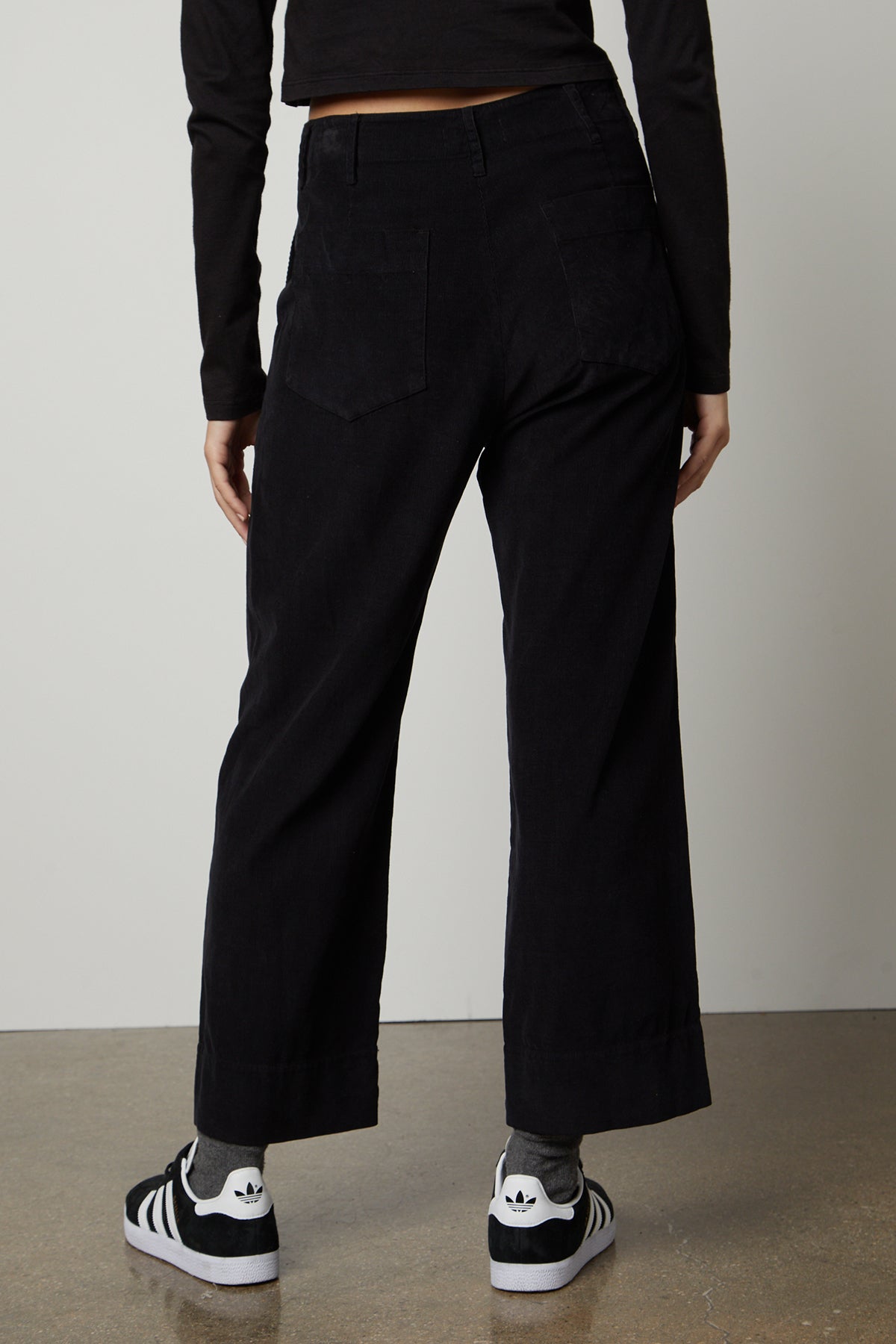 The back view of a woman wearing Velvet by Graham & Spencer VERA CORDUROY WIDE LEG PANT.-26861576487105