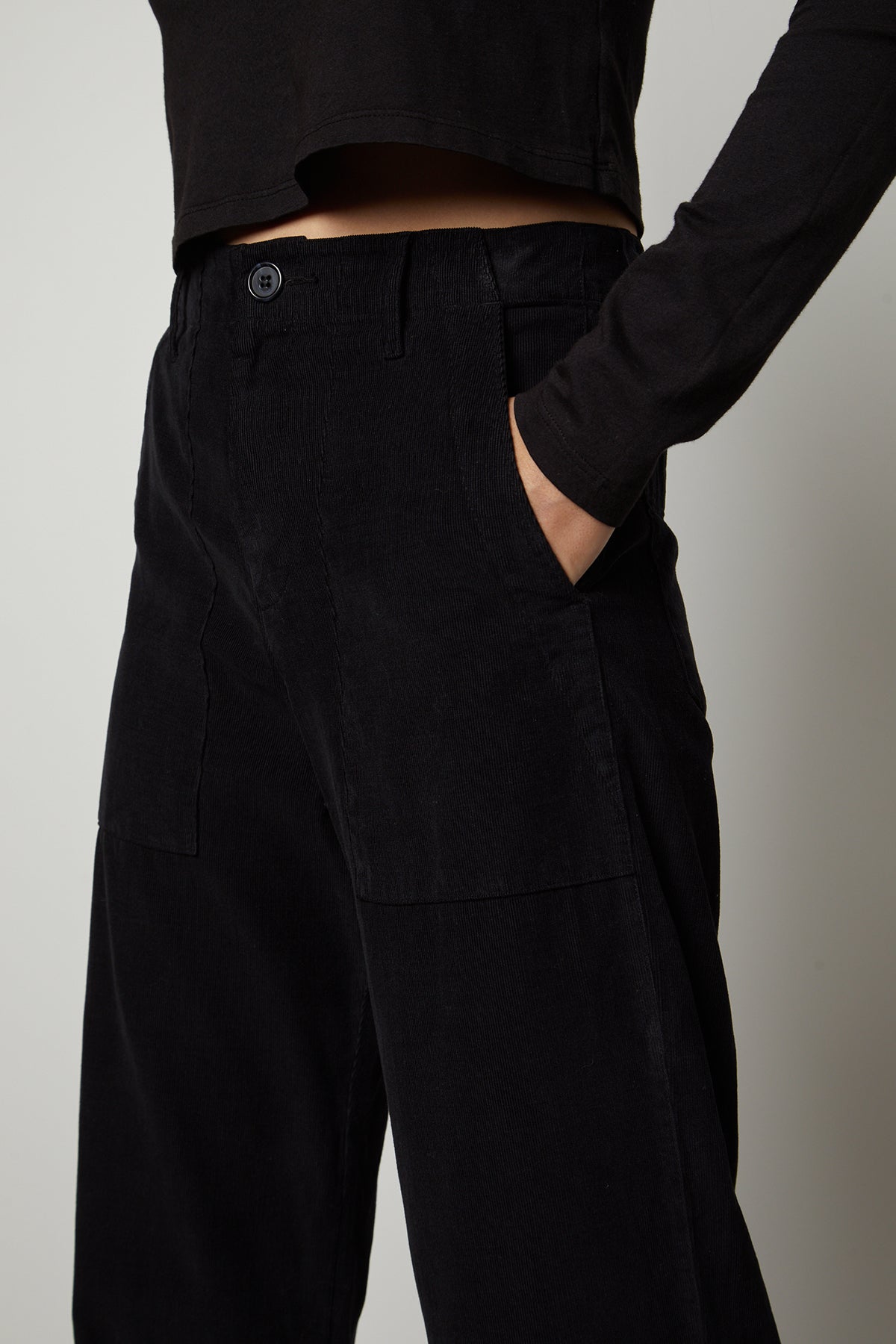   A woman wearing Velvet by Graham & Spencer VERA CORDUROY WIDE LEG PANT and a black top. 
