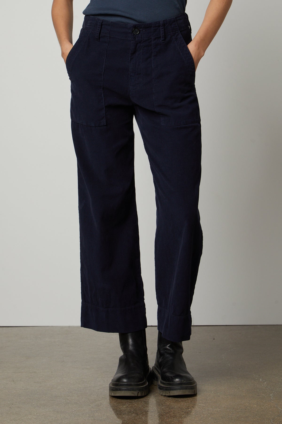   A woman wearing a blue t-shirt and Velvet by Graham & Spencer's VERA CORDUROY WIDE LEG PANT. 