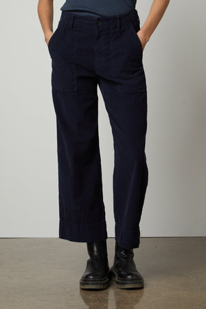 A woman wearing a blue t-shirt and Velvet by Graham & Spencer's VERA CORDUROY WIDE LEG PANT.